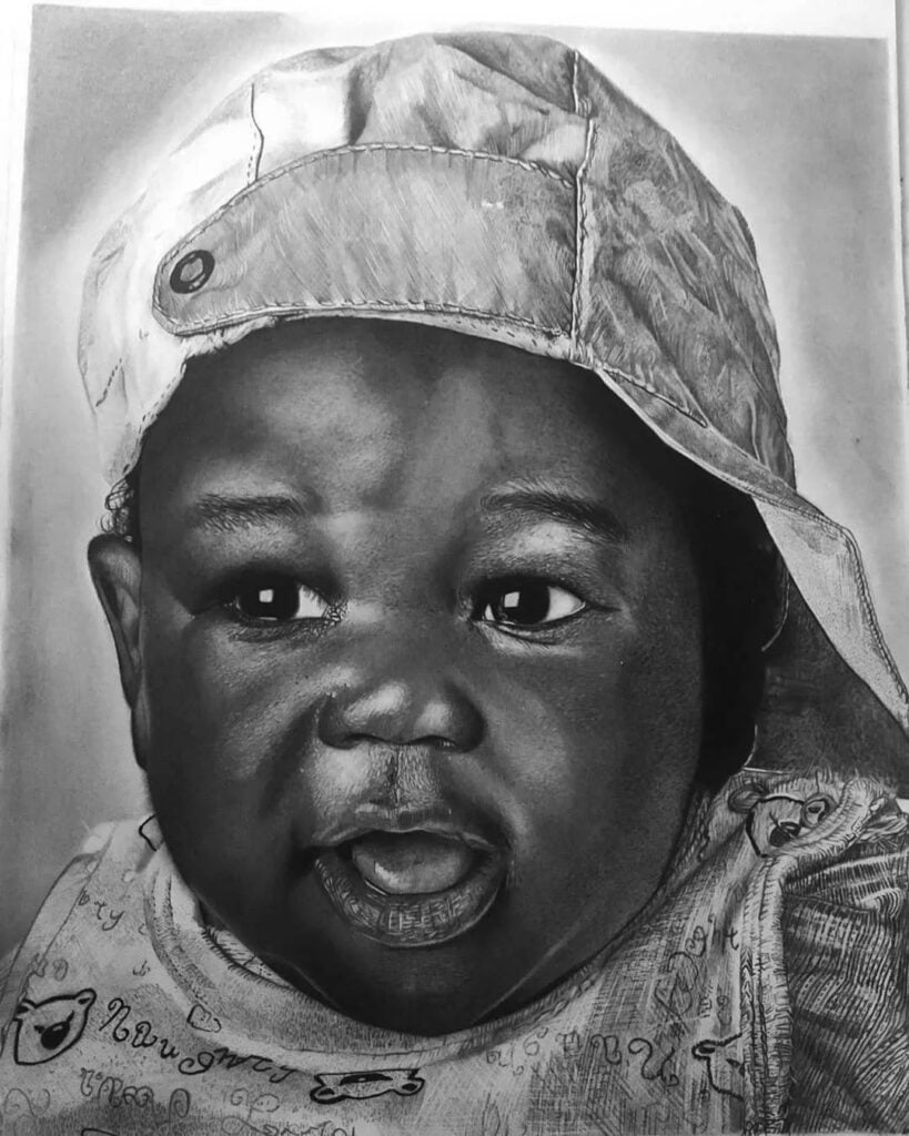 Desenho realista de um bebê feito pelo desenhista Ozias Souza, ilustrando esse estilo de arte.