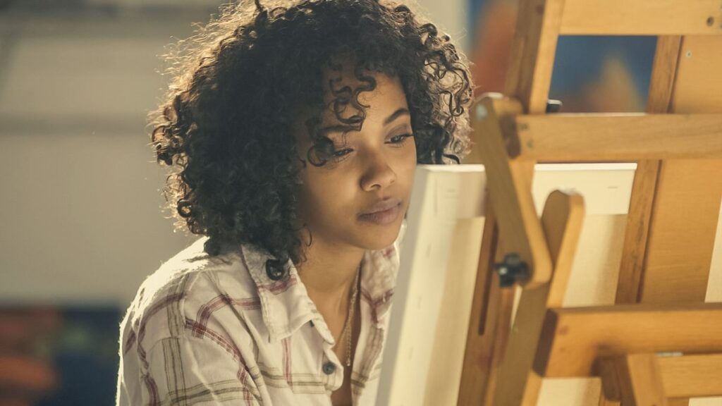 Uma mulher fazendo um quadro, ilustrando a valorização da arte.